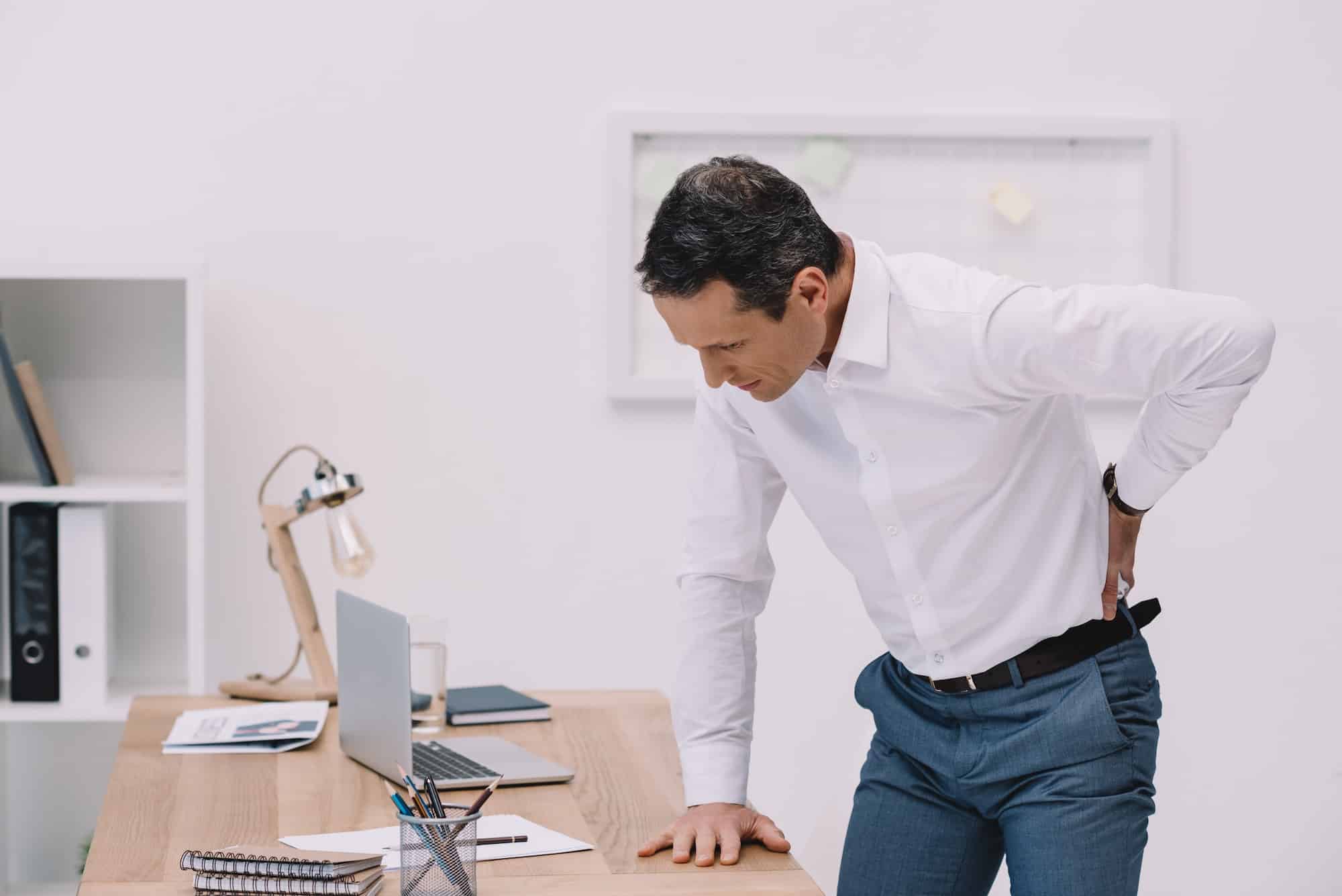 mature-businessman-with-painful-backache-at-office